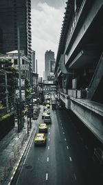 Vehicles on road amidst buildings in city