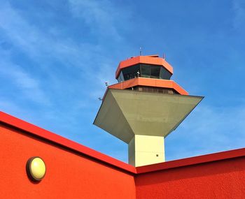Low angle view of air traffic control tower against blue sky