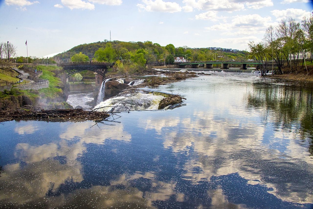 water, reflection, sky, tranquility, cloud - sky, tree, tranquil scene, nature, river, scenics, lake, beauty in nature, cloud, waterfront, rock - object, built structure, day, standing water, outdoors, no people