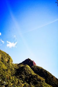 Low angle view of mountain against blue sky