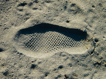 High angle view of footprints on sand at beach