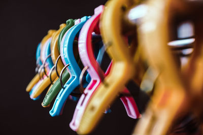 Close-up of colorful clothespins against black background