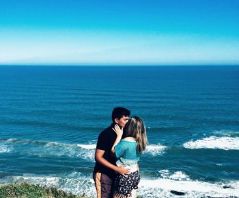Full length of young woman standing on beach