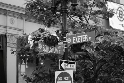 Low angle view of road sign against building