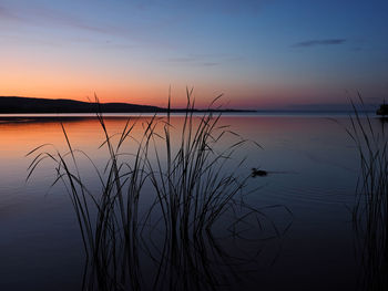 Scenic view of lake against romantic sky at sunset