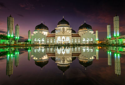 Reflection of illuminated buildings in water at night