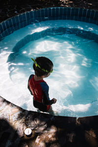 Boy standing in swimming pool