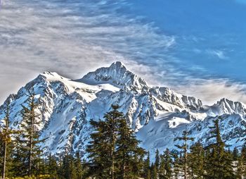 Scenic view of mountains against cloudy sky