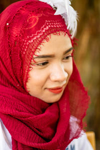 Close-up portrait of a smiling girl in snow