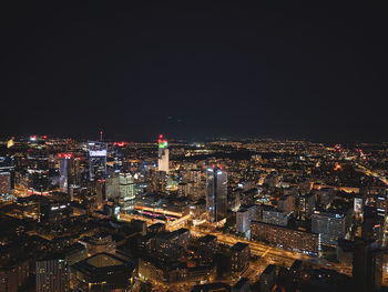 High angle view of city lit up at night