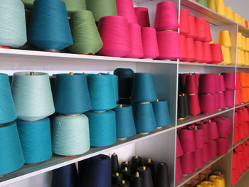 Multi colored spools on shelves in store