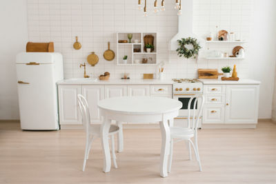 Cozy modern scandinavian style kitchen with dining area, white modern interior