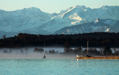 Scenic view of sea against snowcapped mountains