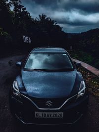Close-up of car on road against sky