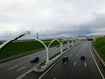 Traffic on highway in city against sky