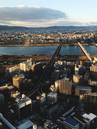 High angle view of illuminated cityscape against sky during sunset