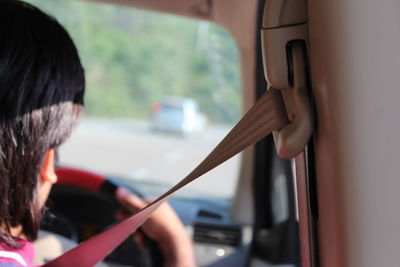 Rear view of man sitting in car