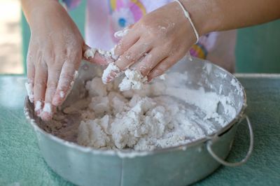 Midsection of woman preparing food in bowl