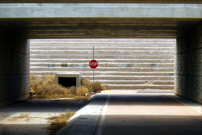 Stop sign beneath underpass