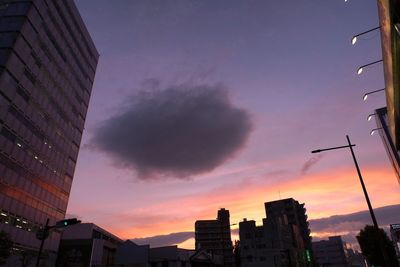 Low angle view of buildings against sky at sunset