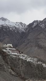 View of castle on mountain against cloudy sky