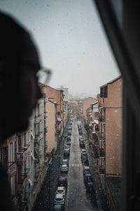 City buildings seen through wet window
