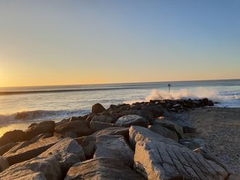 Scenic view of sea against clear sky during sunset