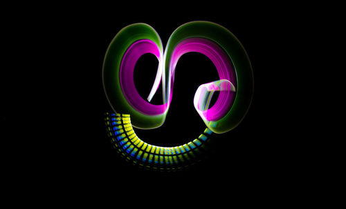 Close-up of illuminated light over black background