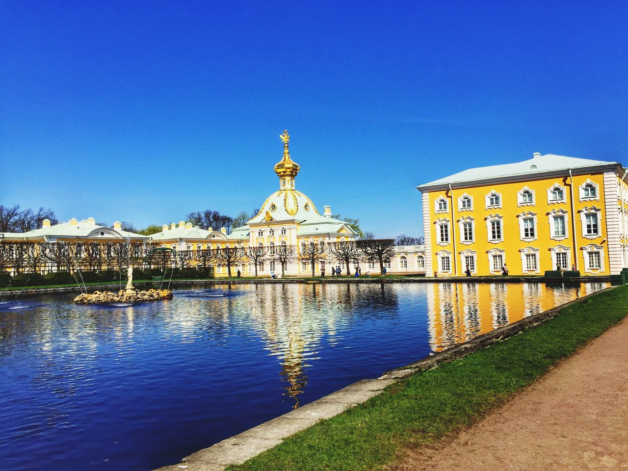 clear sky, architecture, building exterior, built structure, blue, copy space, water, religion, famous place, place of worship, travel destinations, spirituality, dome, history, tourism, sunlight, day, travel, outdoors, reflection