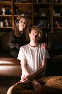 Portrait of young couple sitting at home