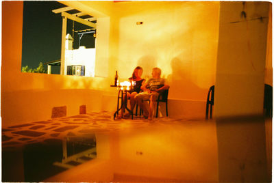 People sitting on table at home