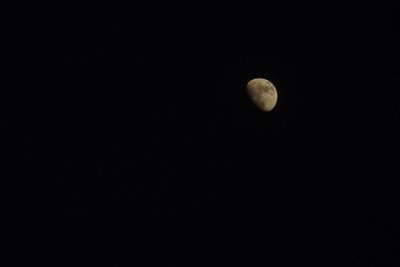 Low angle view of half moon against sky at night