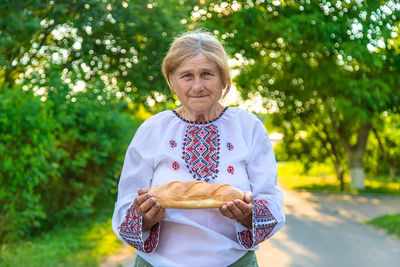 Portrait of woman holding bread