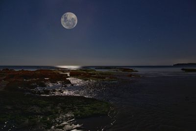 Scenic view of moon over sea