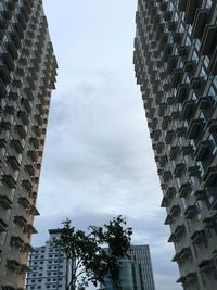 Low angle view of buildings against sky in city