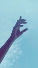 Low angle view of hand against sky