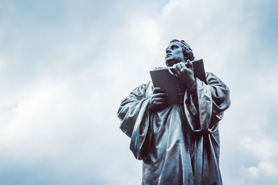 Low angle view of statue against sky