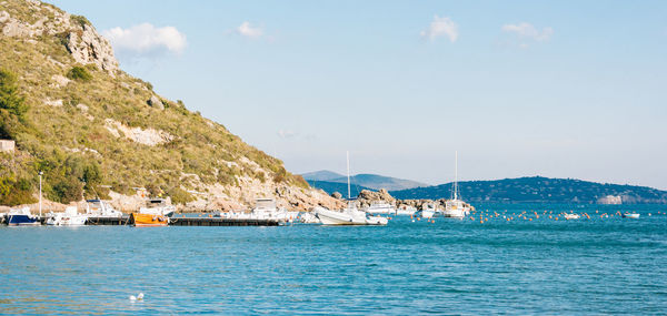 Scenic view of boats in sea against sky