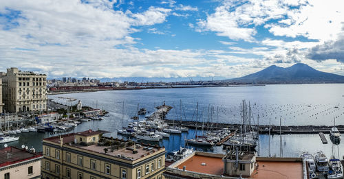 High angle view of buildings by sea against sky