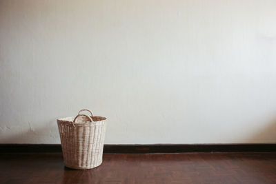 Close-up of wicker basket by wall