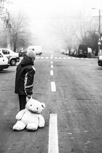 Full length of woman standing on road