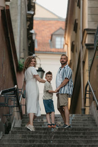 Portrait of smiling couple standing in city