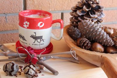 Close-up of coffee with pine cones on table