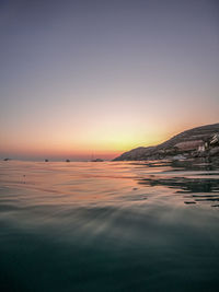 Scenic view of sea against clear sky during sunset