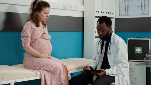 Female doctor examining patient in hospital