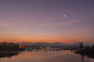 Scenic view of lake against sky at night