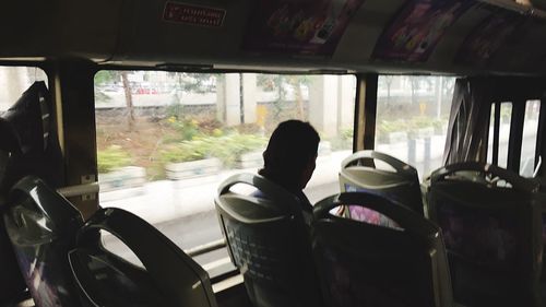 Rear view of man sitting in bus