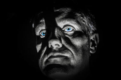 Close-up of mask against black background