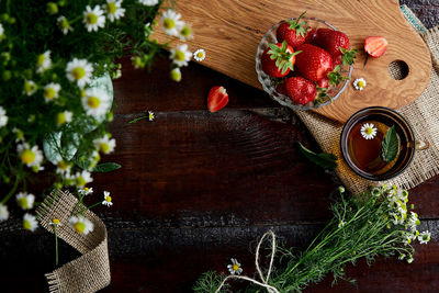 Natural organic breakfast. fresh strawberries, summer chamomile flowers, herbal tea and mint  