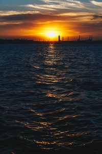 View of sea against cloudy sky during sunset